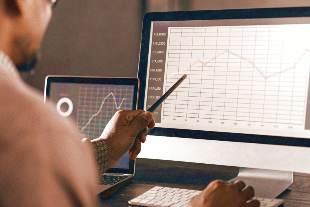 A specialist analyzes SEO growth charts for a website on his computer screen.